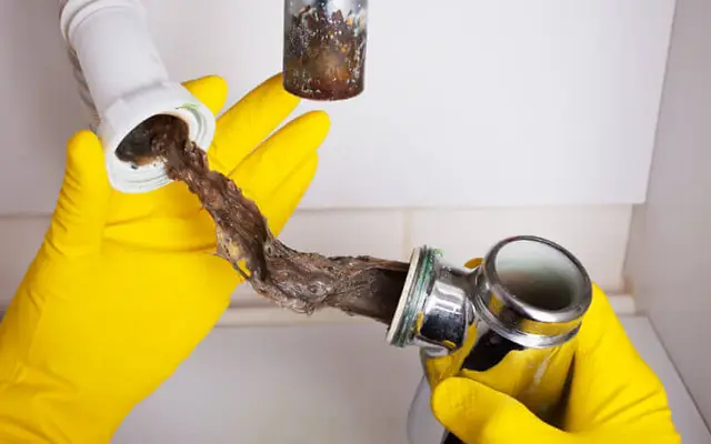 Clogged drain causing basement flooding and requiring water damage repair services