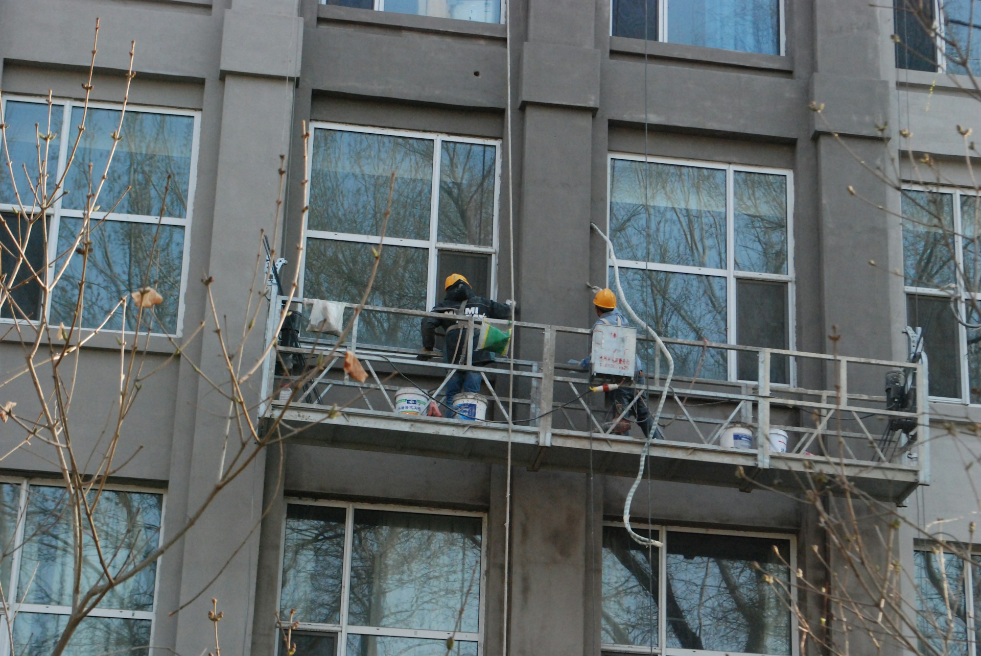 Alta Property Services technician performing routine building maintenance inspection at a Chicagoland commercial property