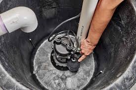 Alta Property Services certified technician inspecting sump pump system in Addison Illinois home
