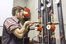 Alta technician performing sump pump repair in Arlington Heights IL basement