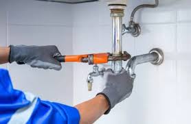 Professional HOA plumbing and electrical repair technician at work