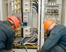 Certified technician performing electrical maintenance on building systems