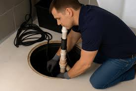 Alta Property Services technician performing sump pump repair in Glen Ellyn IL basement