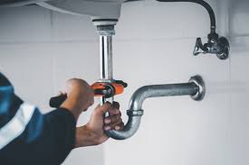 Alta technician performing emergency sump pump repair in a Woodridge IL basement
