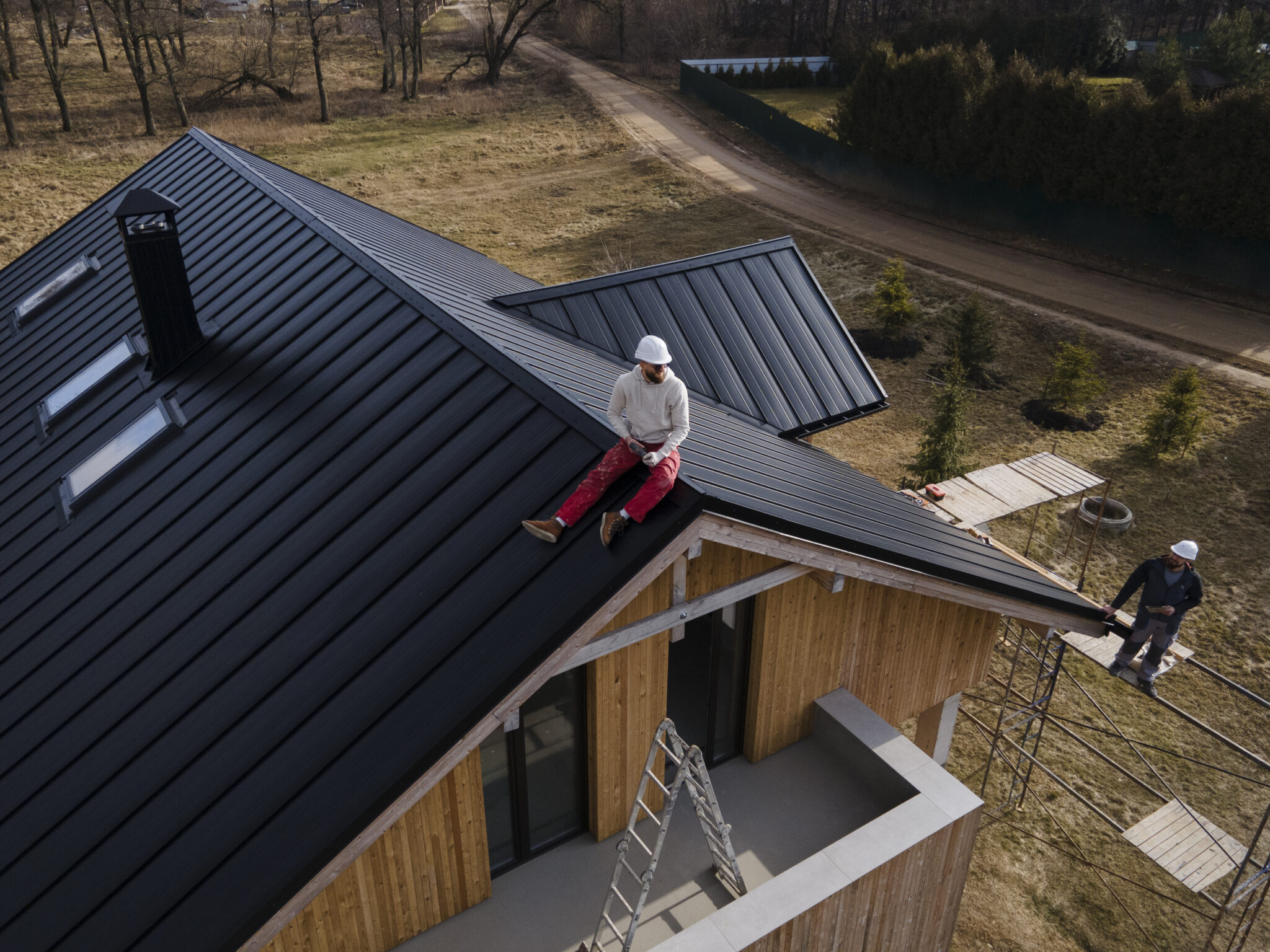 Alta Property Services crew member on-site assessing storm damage to siding and roof in DuPage County Illinois