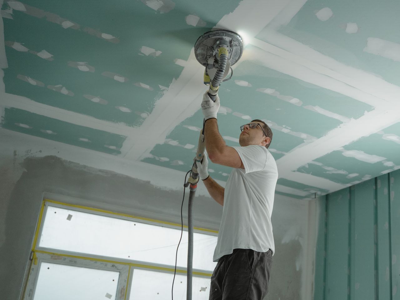 Alta Property Services technician performing ceiling repair and drywall restoration in a DuPage County home